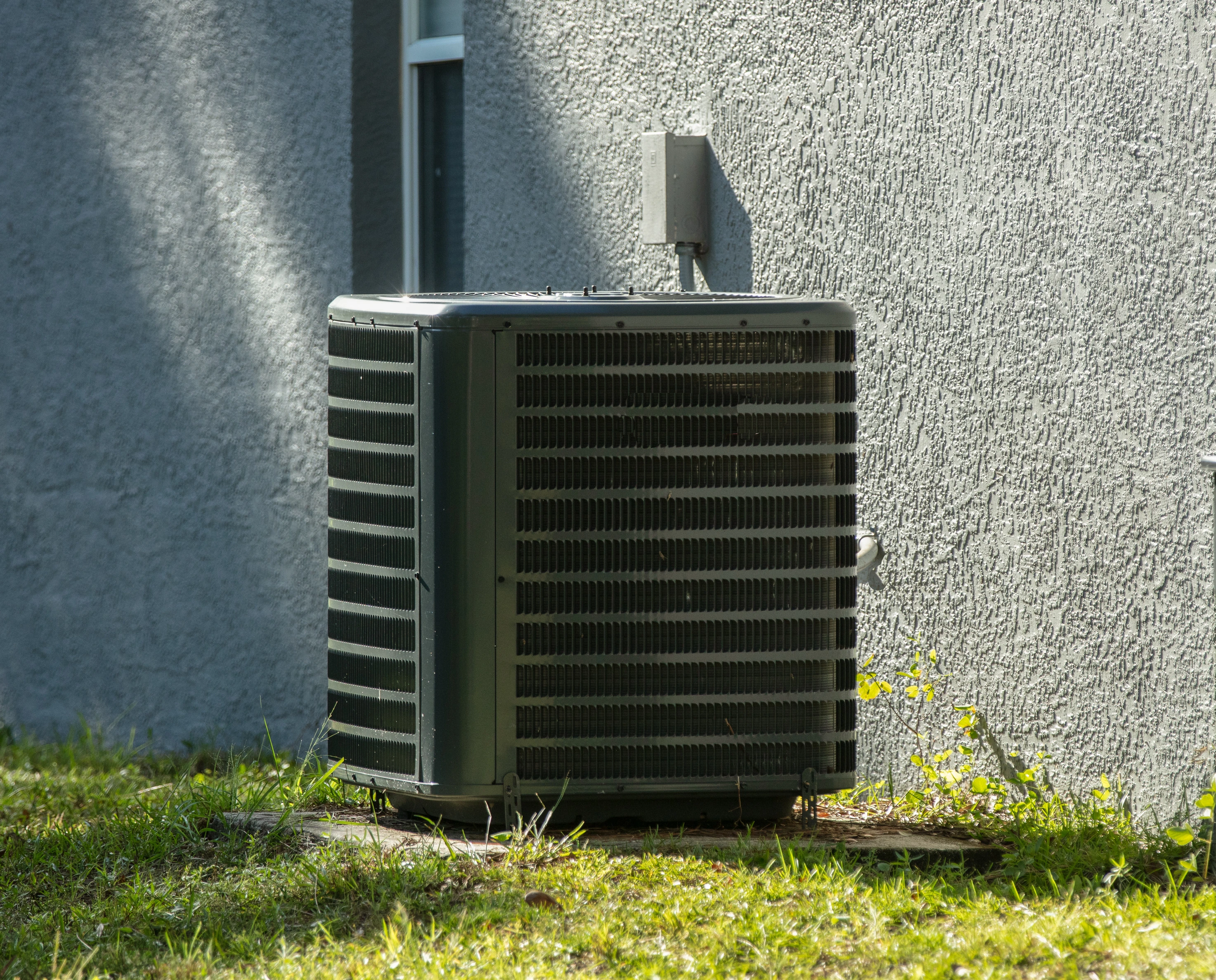 An outdoor HVAC condenser unit in Tulsa after professional AC repair from Air Dynamics.