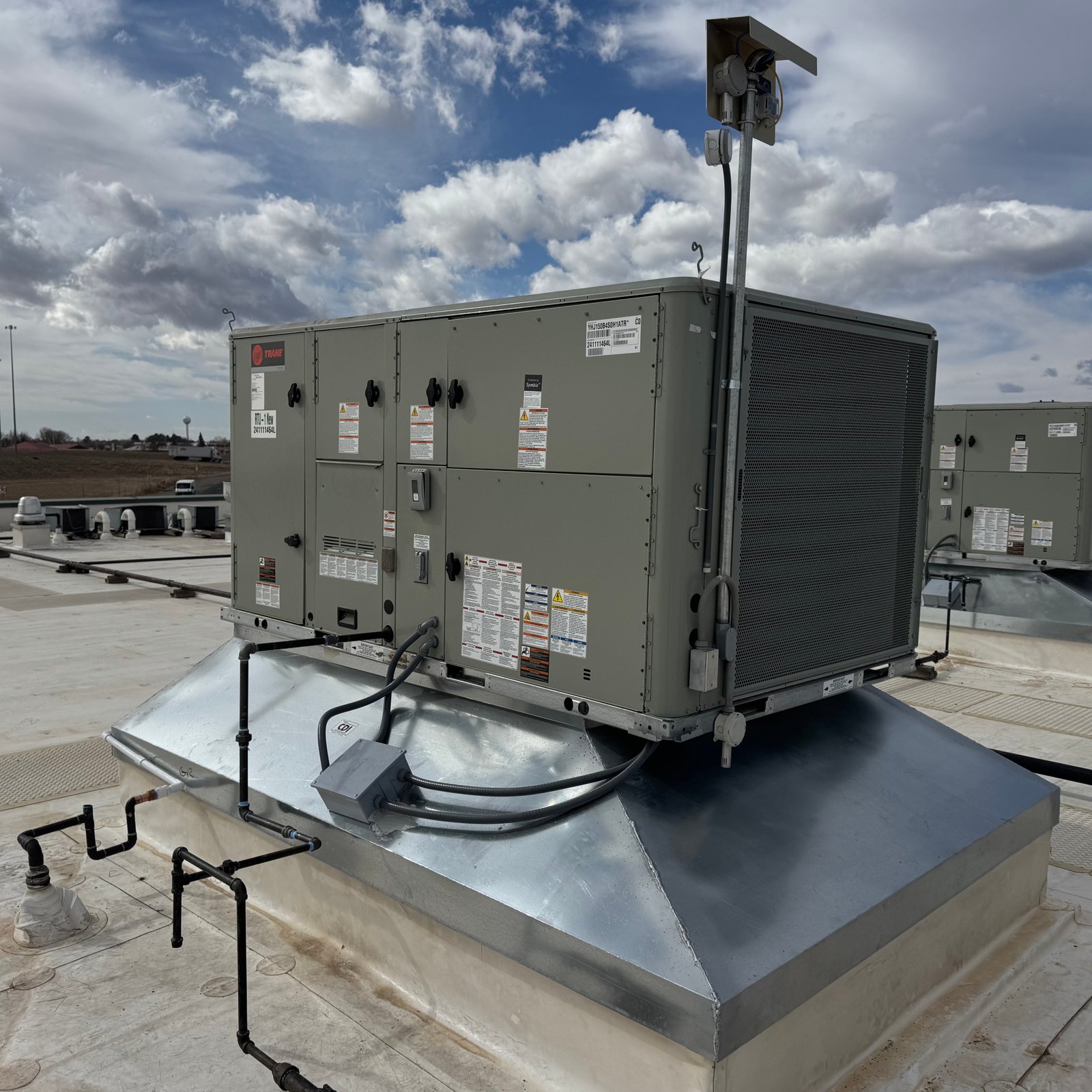 Air Dynamics of Tulsa technician diagnosing an HVAC issue during a service call.